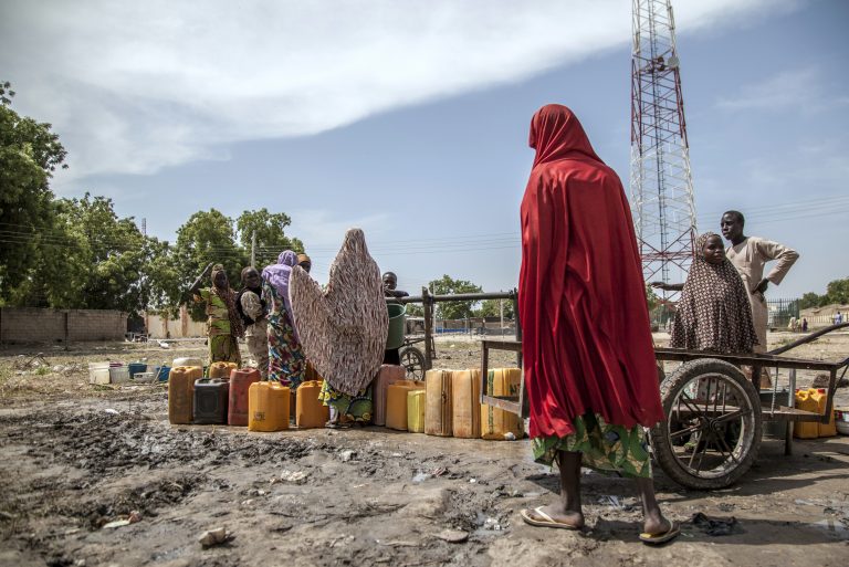 Women and children collect water in Mafa IDP camp, Borno state, north-east Nigeria.