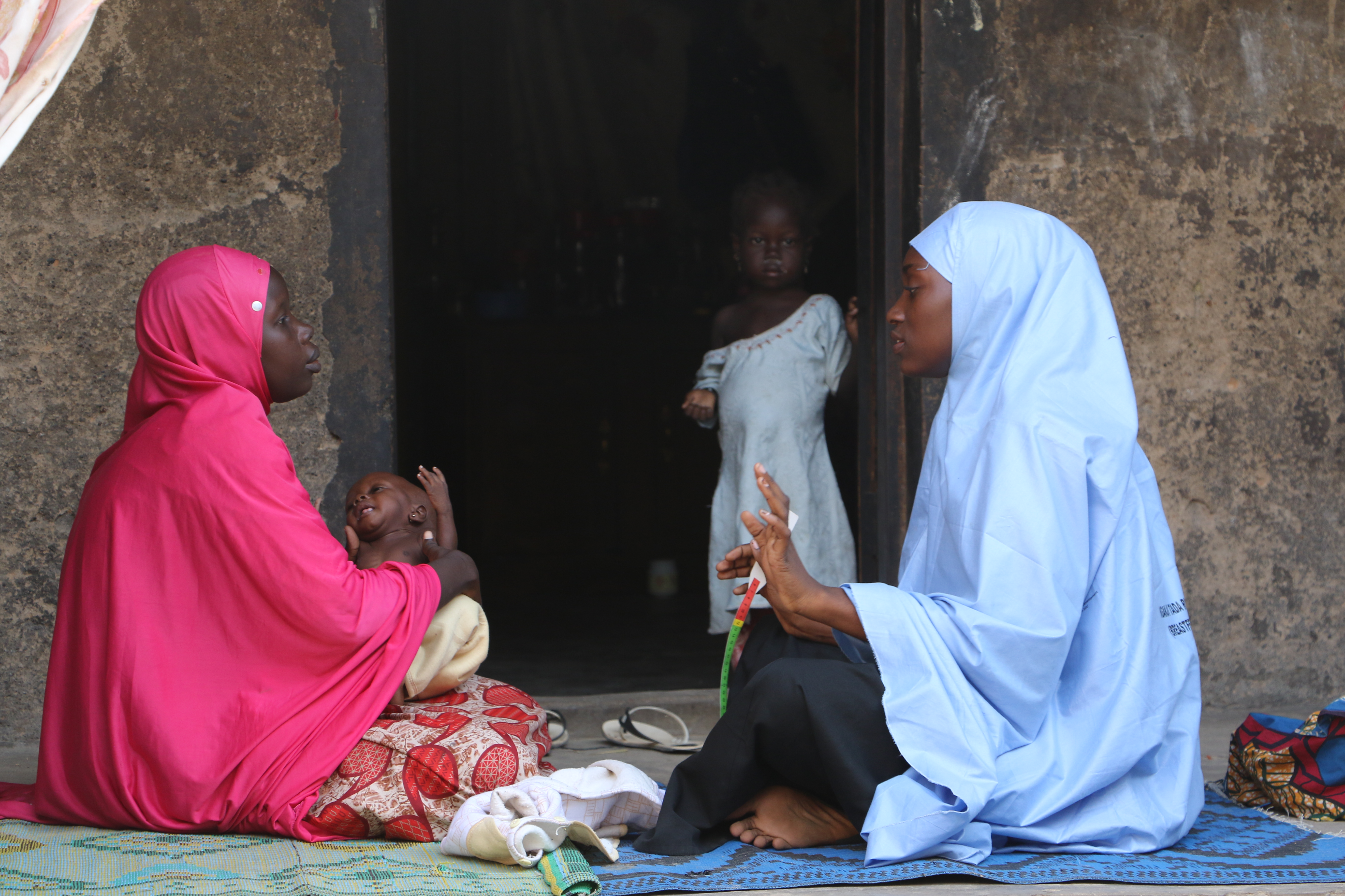 A volunteer visits a displaced family in Maiduguri