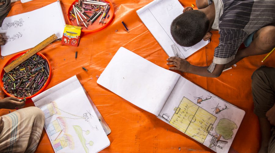 Rohingya children in a UNICEF child-friendly space at Batukhali refugee camp in Bangladesh draw pictures of what they witnessed in Burma.