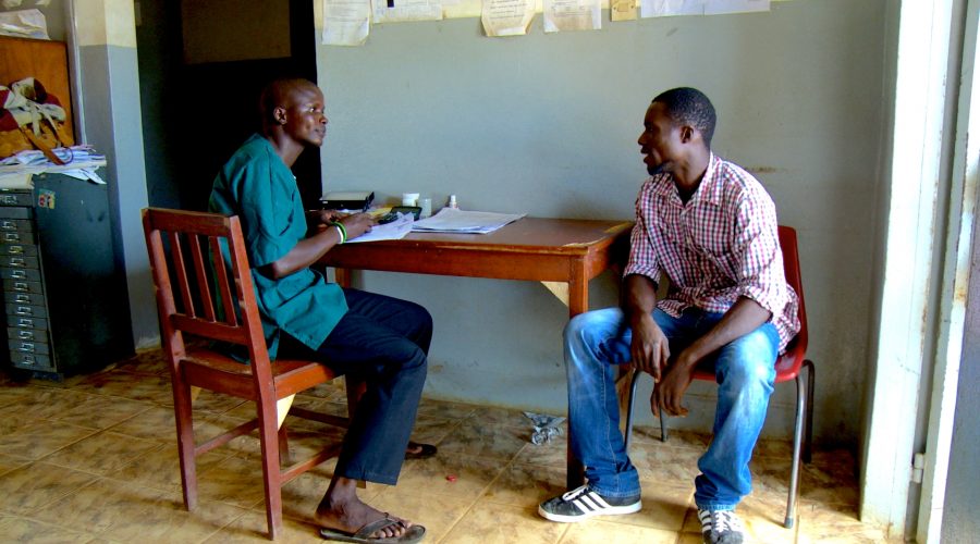 Ebola survivor Abdul Rahman Sanu counsels a patient at a health centre in Sierra Leone.