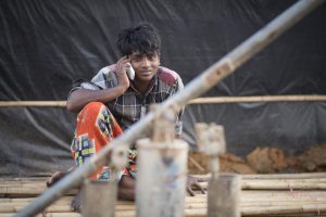 Rohingya young man and mobile phone.
