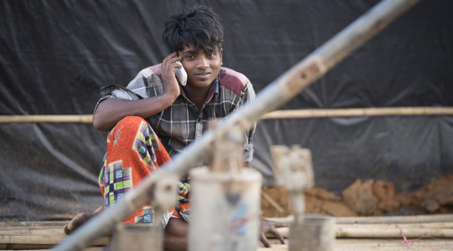 Rohingya young man and mobile phone.
