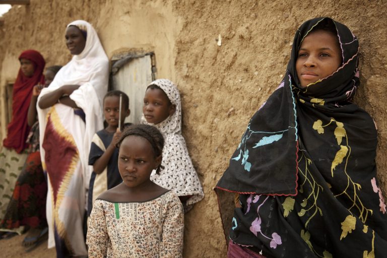 Women and girls stand in the shade in Kidal, northern Mali.