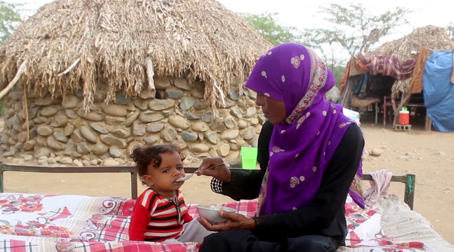 A mother feeding her daughter in the malnutrition hit Aldhahi district after a nutrition awareness session.