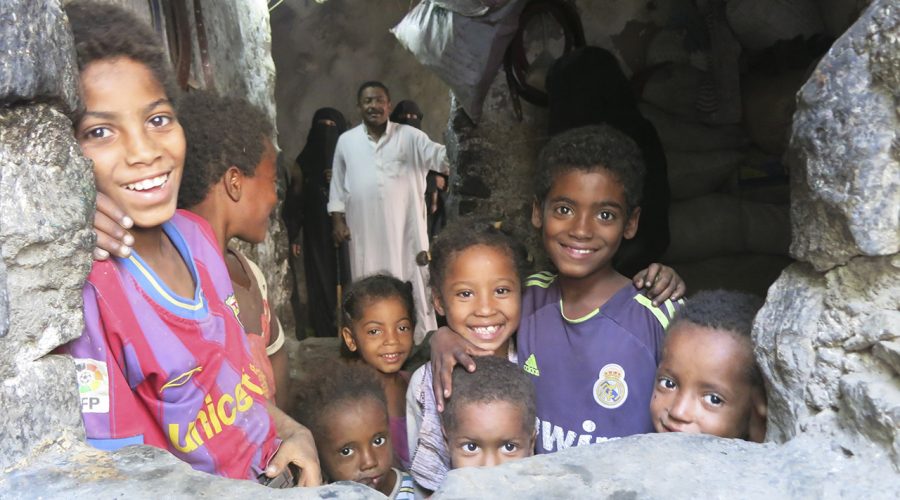 Dhamar, Wusab Assafil district. Hameed, 60 year-old grandfather, poses with some women and children of his big family of 34 members