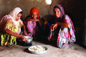 In the Aldoosh Village in Yemen, Ayesha and her children prepare food for dinner.