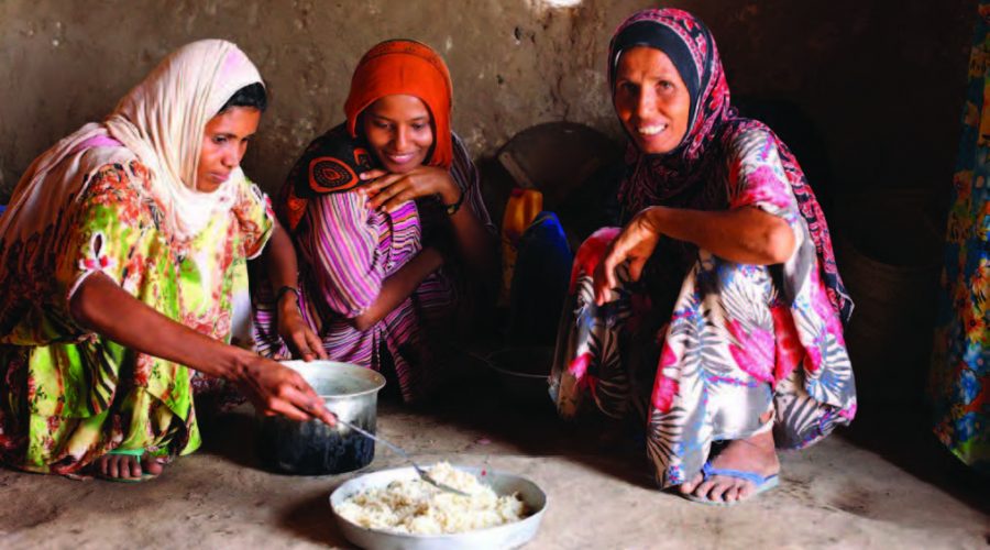 In the Aldoosh Village in Yemen, Ayesha and her children prepare food for dinner.