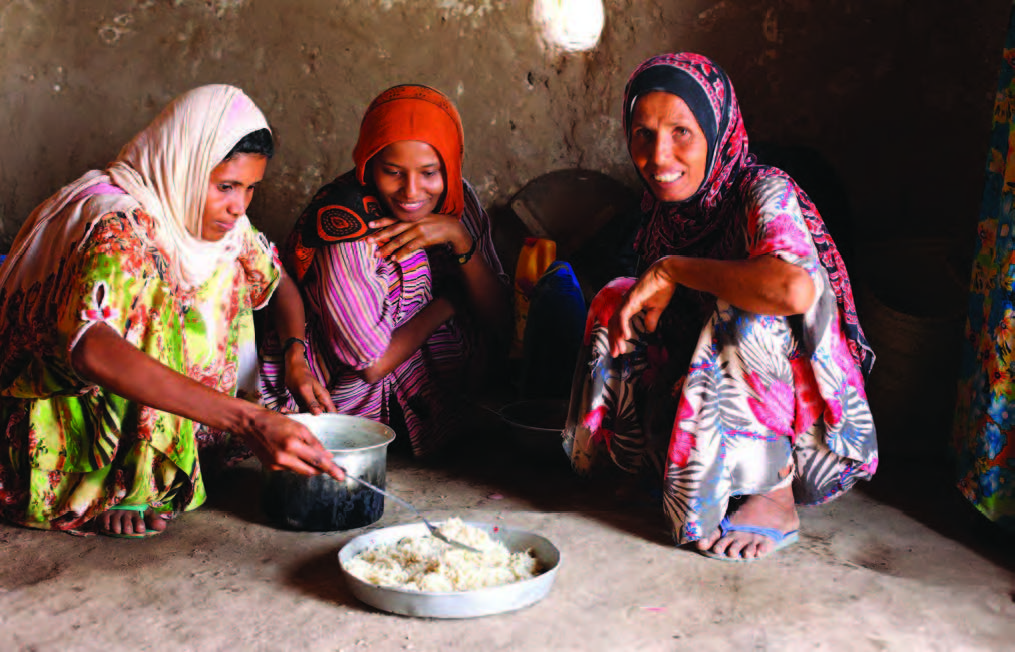 In the Aldoosh Village in Yemen, Ayesha and her children prepare food for dinner.