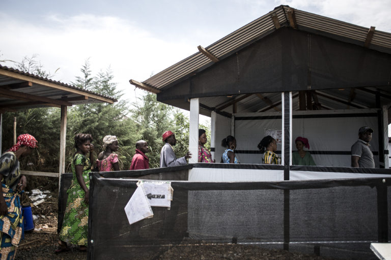 People are seen lining up to get their temperature checked at an MSF supported triage, before heading into Bunia’s general hospital.