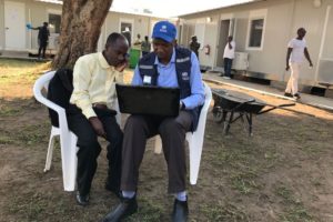 Two surveillance officers discussing Key Performance Indicators in the Emergency Operations Center in Beni, North Kivu.