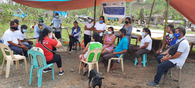 PDRRN Interim Response Manager Ann Ria S. Barrera consults with the officers of the Relocation Area Community Association (RACA) in Virac, Catanduanes for Super Typhoon Goni (locally known as Typhoon Rolly) in November 2020.