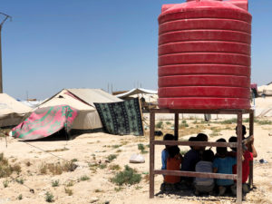 North East Syria, Al Hassakeh Governorate, Al Hol camp for internally displaced persons. Children in the shadow of a water tank.
