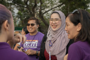 We are making sure the bulk of our resources go to our partners," says Maria Rosario Felizco, director of Oxfam in the Philippines (right), shown here speaking with staff of United Youth of the Philippines-Women and the Al Mujadillah Development Foundation at an International Women's Day celebration in 2020.