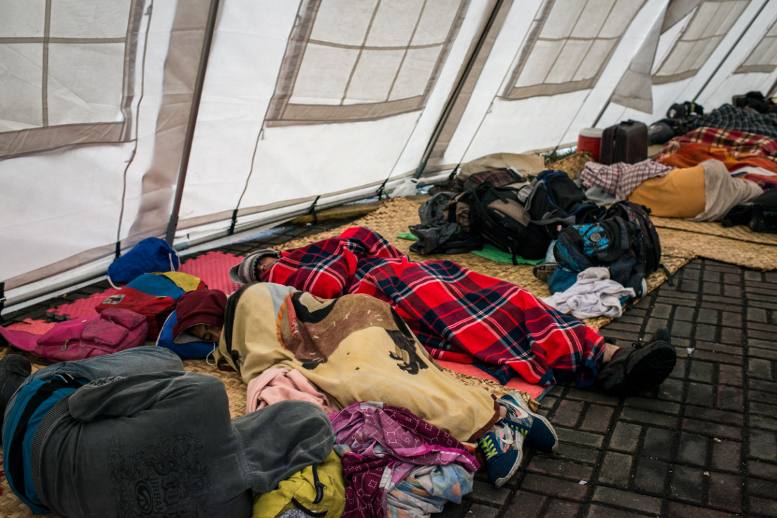 Migrant women and children shelter in tents next to the Red Cross health centres at the Colombian border, 2018.