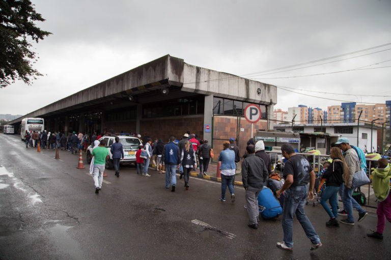 Migrants arrive at a bus station in Bogotá, Colombia, 2018.
