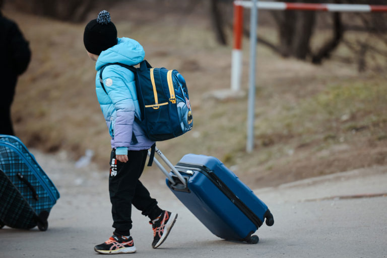Ukrainian children crossing the border into Romania